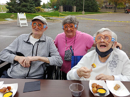 From left: Don Wells, Susan Newville, and Helen Wells got a kick out of the pretzel glasses available to festers.